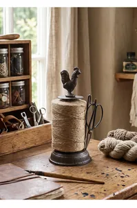 Detailed view of vintage cast iron rooster twine holder with jute string and scissors