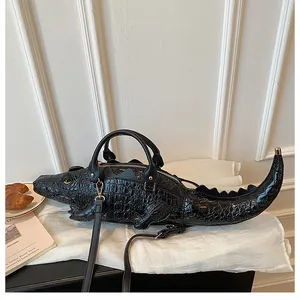 Side view of creative 3D crocodile shaped handbag with textured black leather finish