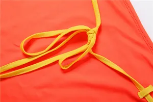 Vue détaillée des bretelles jaunes nouées sur un ensemble sexy orange vif moulant