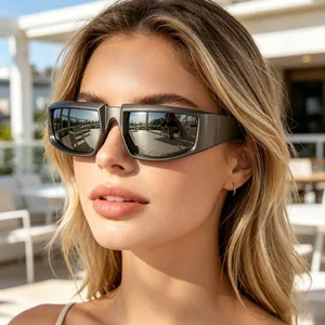 Close-up of stylish steampunk wrap-around sunglasses on female model outdoors
