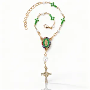 Detail of cross charms and Virgin Mary medal with green enamel and pearls