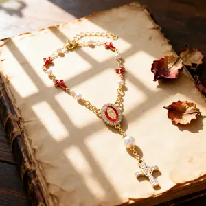 Macro detail of golden religious bracelet with cross pendants and pearl beads on book