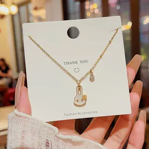 Cute gold rabbit pendant necklace with crystal charm on display card
