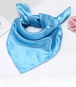 Macro shot of light blue satin square scarf featuring silky texture and fine edge stitching