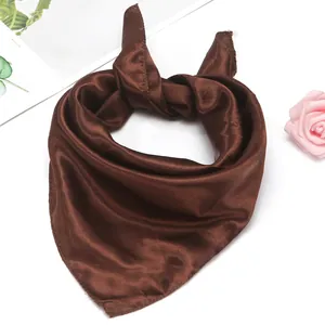 Macro detail of silk-like coffee brown neckerchief with elegant satin sheen and edge stitching