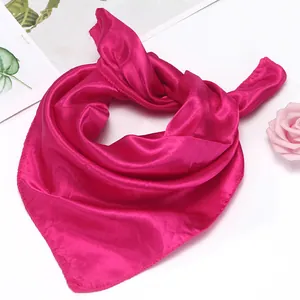 Detailed view of fuchsia silk square scarf with a smooth finish and neat edges