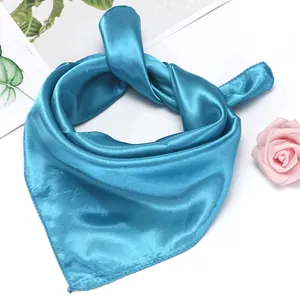 Macro shot of glossy bright blue satin neckerchief showing smooth texture and drape