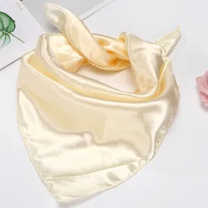 Detailed view of the champagne satin scarf showing its smooth texture and edge finish