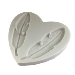 Heart-shaped silicone mold featuring two delicate feather designs for DIY craft projects.