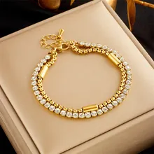 Detail of dual-layer gold chain bracelet with rhinestones on a jewelry display box