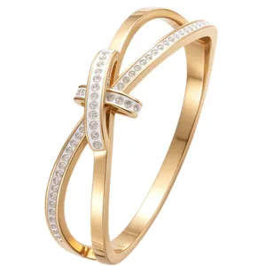 Elegant gold-plated stainless steel horseshoe knot bangle bracelet with crystal pavé details