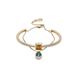 Elegant gold-tone bangle bracelet with square yellow stone and green teardrop zircon