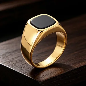 Elegant men's gold plated stainless steel signet ring with a square black stone inlay.