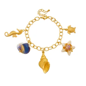 Golden stainless steel ocean charm bracelet with seahorse and starfish pendants