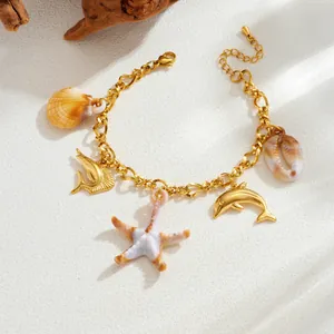 Detailed view of a gold plated stainless steel ocean theme charm bracelet with starfish.