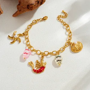 Gold-plated stainless steel ocean charm bracelet with starfish, lobster, and fish.