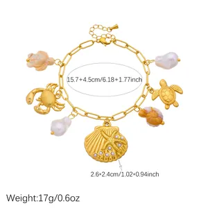 Gold ocean charm bracelet with detailed shell and sea turtle measurements displayed.
