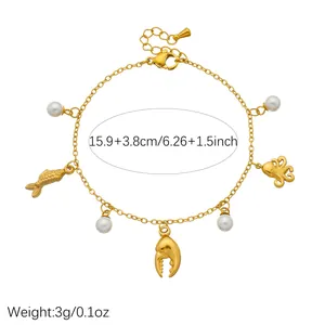 Detail of gold-plated stainless steel ocean charm bracelet with pearls and pendants
