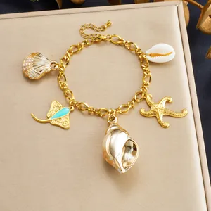 Gold-plated stainless steel ocean charm bracelet featuring shell and starfish pendants