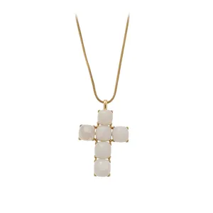 Elegant gold snake chain necklace featuring a white resin stone cross pendant design