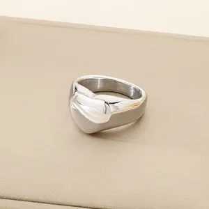 Elegant minimalist heart-shaped polished titanium steel ring with a smooth silver finish