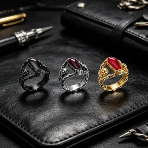 Set of Gothic skull and coffin rings in black, silver, and gold with red resin details