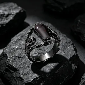 Macro detail of gothic skeleton coffin ring in vintage titanium steel with red inlay