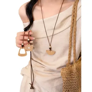 Elegant Bohemian woven straw necklace with long adjustable cord and wooden bead accents