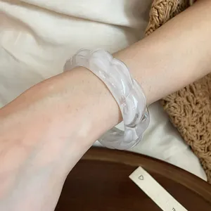 Detailed view of bohemian acrylic bracelet featuring an elegant white marbled swirl pattern