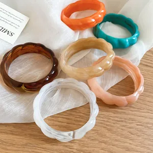Detailed view of bohemian wavy marble-effect acrylic bangles in six vibrant summer colors