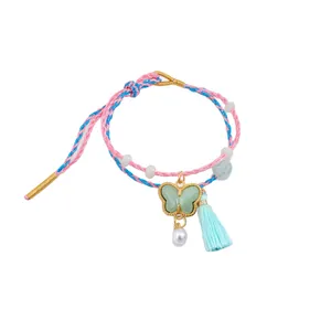 Handcrafted braided colorful rope bracelet with green butterfly charm and tassel.
