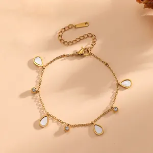Minimalist gold stainless steel bracelet featuring white teardrop charms and CZ stone accents