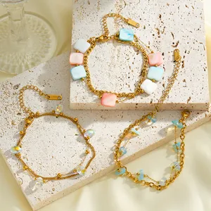 Detailed view of 18K gold plated stainless steel bracelets with colorful acrylic