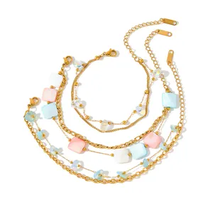Detail of 18K gold plated stainless steel bracelets with colorful acrylic charms