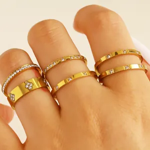 Detailed view of gold-plated stainless steel rings with zircon stacking on fingers.