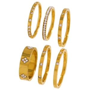 Close-up of golden stainless steel stacking rings set with shiny cubic zirconia stones