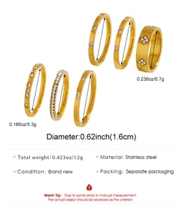 Detailed view of a stainless steel gold ring set with zircon and clover pattern designs