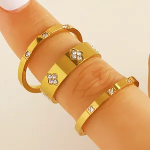 Detail of three-piece gold stainless steel rings with zircon stacking on finger