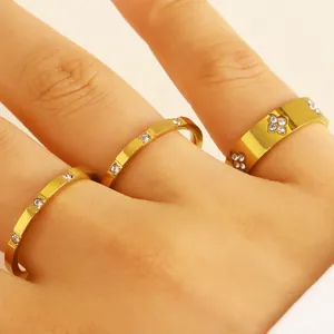 Close-up view of three gold-plated stainless steel rings with zircon on a hand