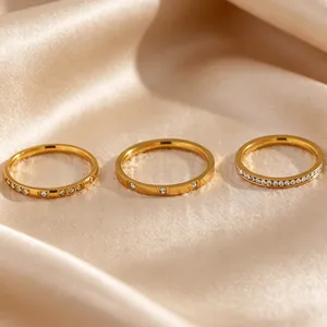 Detail view of three gold-plated stainless steel stackable rings with zircons