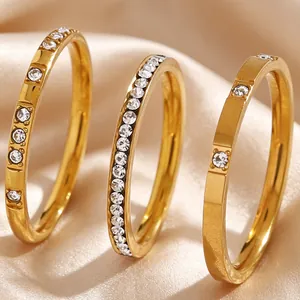 Detailed macro shot of three gold-plated stainless steel rings with sparkling zircon on silk