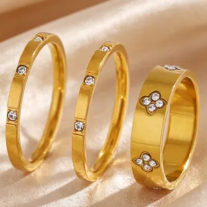 Detailed view of three golden stainless steel rings featuring zircon flower patterns