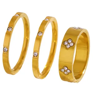 Detail view of a three-piece set of gold-plated stainless steel rings with zircons.