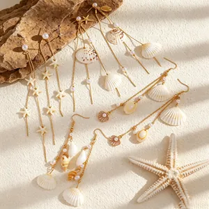 Close-up detail of ocean theme tassel earrings featuring sea shells and faux pearls