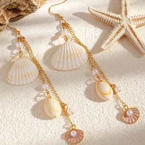 Detail view of beach tassel earrings featuring imitation pearls and delicate shell pendants.