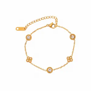 Close-up of elegant 18K gold plated chain bracelet with flower and zircon charms