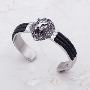 Bracelet manchette vintage en cuir tressé et acier inoxydable tête de lion pour homme.