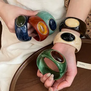 Vintage bold acrylic marbled bangles with oval resin inlay stones for resort style jewelry