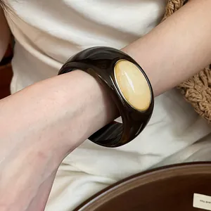 Detailed macro view of a vintage acrylic bangle with a marbled oval stone inlay