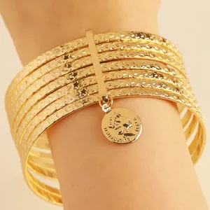 Vintage gold alloy 10-piece bracelet set featuring embossed stars and coin charm